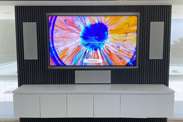 TV in a wall with a 3 covered speaker setup