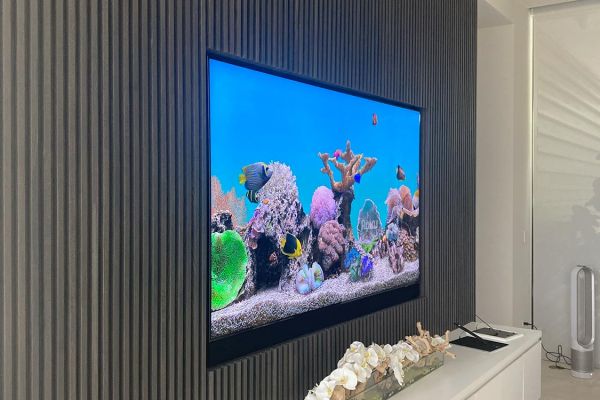 TV in a wall with a white shiny furniture