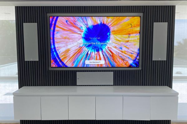 TV in a wall with a 3 covered speaker setup