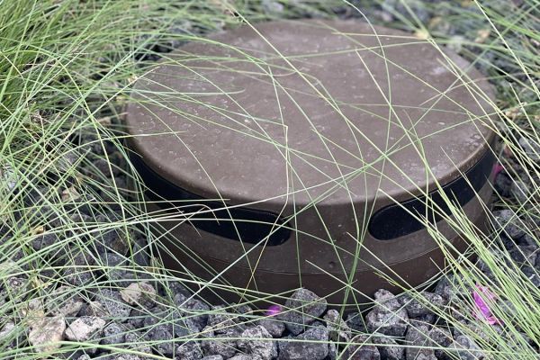 outdoor speaker with pebbles around