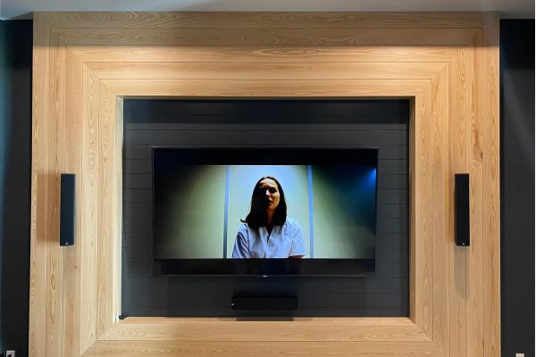 TV in a wooden wall with 2 side speakers