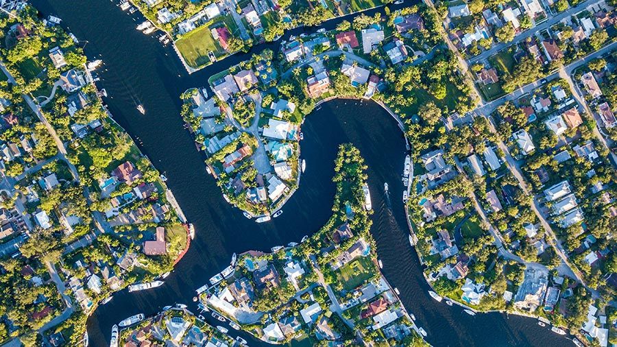 Aerial view of winding canals lined with homes and boats